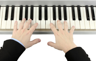 hands of man playing piano