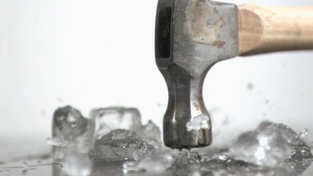 Hammer in super slow motion crushing ice cubes