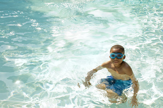 African American boy swimming in swimming pool