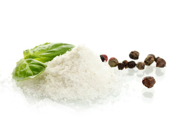 salt and pepper with fresh basil isolated on white