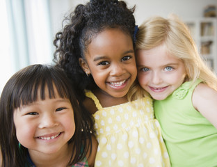 Smiling girls hugging each other