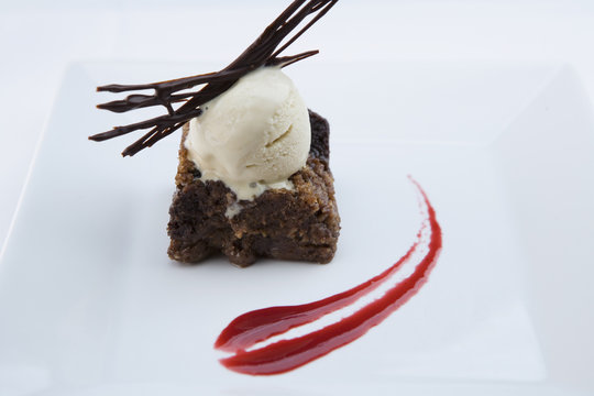 Elegant brownie dessert on plate with ice cream
