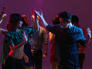 Fototapeta premium happy young people dancing in night club