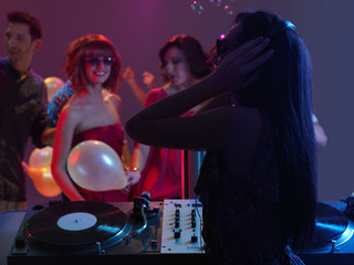 woman dj entertaining crowd in night club