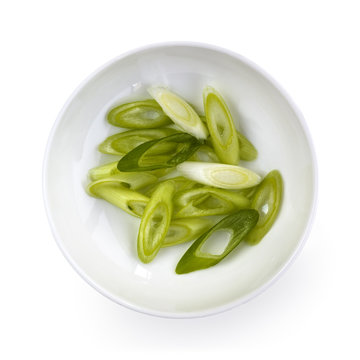 Sliced Spring Onions in Bowl over White