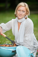 Female Preparing Food On Barbecue