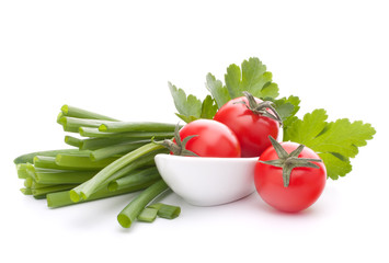Spring onions and cherry tomato in bowl