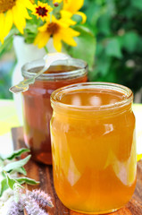 Two jars of honey (buckwheat and meadow one) in the garden