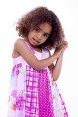 Little girl with pink dress and shy expression