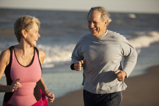 Couple running together on beach