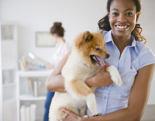 Mixed race woman holding Pomeranian dog
