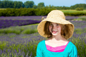 Cute young girl in a field of purple lavender