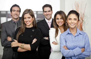 Hispanic business people standing together in office