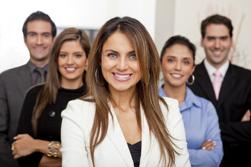 Hispanic business people standing together in office