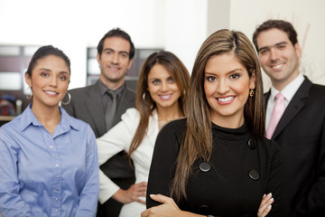 Hispanic business people standing together in office
