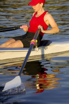 Person rowing sculling boat on river