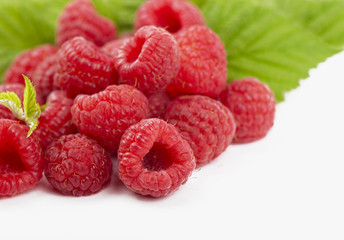 raspberries with leaves isolated on white background