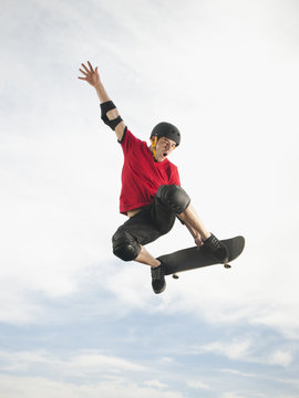 Caucasian man on skateboard in mid-air