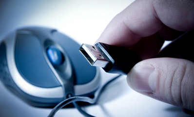 isolated mouse and hand holding usb