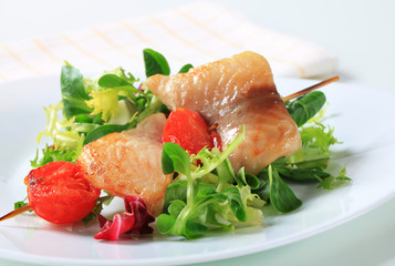 Fish skewer and salad greens