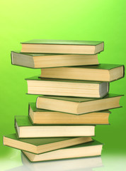 Tower of books on green background