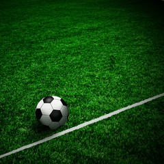 Fototapeta na wymiar Soccer ball on the green field