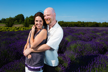Happy middled aged couple in a field of purple lavender