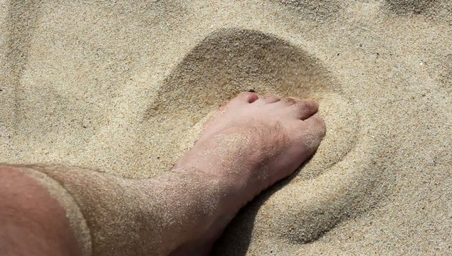 Bare foot on the sand beach