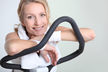 Woman resting for a moment on an exercise machine
