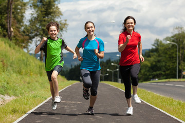 Active family - mother and kids running outdoor