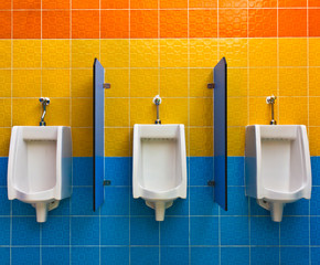 Urinals on colorful wall in public toilet