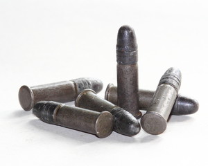 six rifle cartriges over white