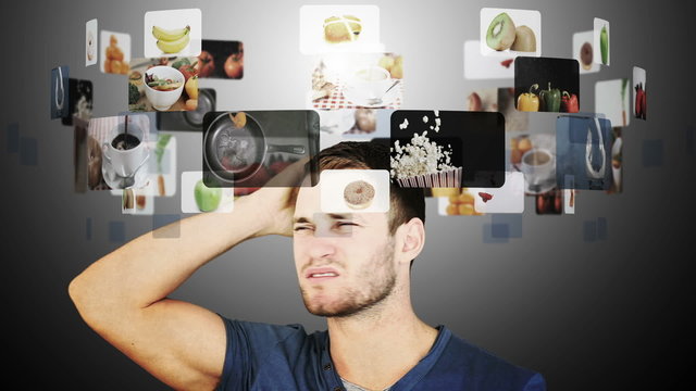 Brunette man hesitating between slow motion videos of food