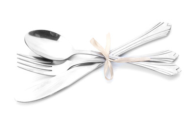 Silver fork, spoon and knife tied with ribbon isolated on white