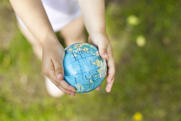 holding an earth globe in hands