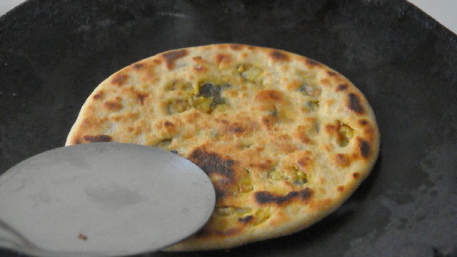 close up of cooking of indan stuffed bread 'parantha'