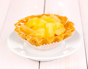 sweet cake with fruits on wooden background