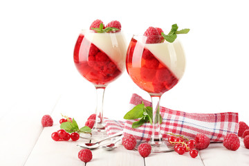 fruit jelly with berries in glasses on wooden table