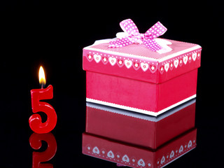 Birthday  gift with red candles showing Nr. 5