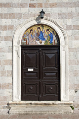 Door and mosic of Orthodox Church of Holy Trinity in Budva