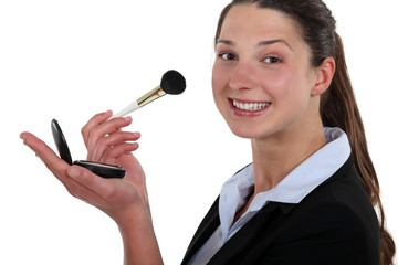 Businesswoman applying blushed