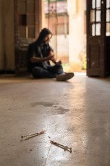 Substance abuse, young man injecting drug with syringe