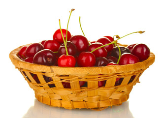 cherry in wicker bowl isolated on white