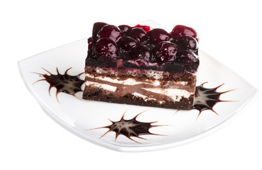 Chocolate cake with cherry on top on a white background