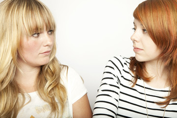 blond and red haired girl are upset