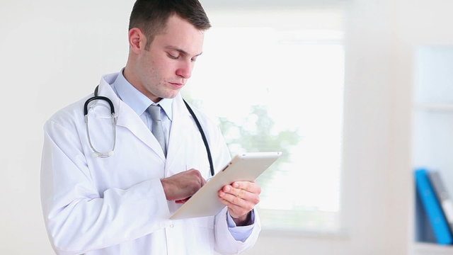 Young doctor using a tablet computer