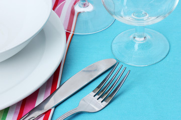 Table setting with fork, knife, plates, and napkin