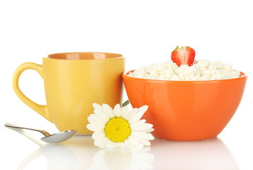 cottage cheese with strawberry in orange bowl and orange cup