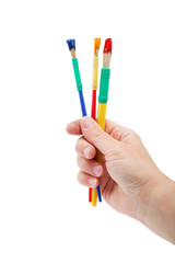 Female hand holding colorful brushes for drawing, isolated over