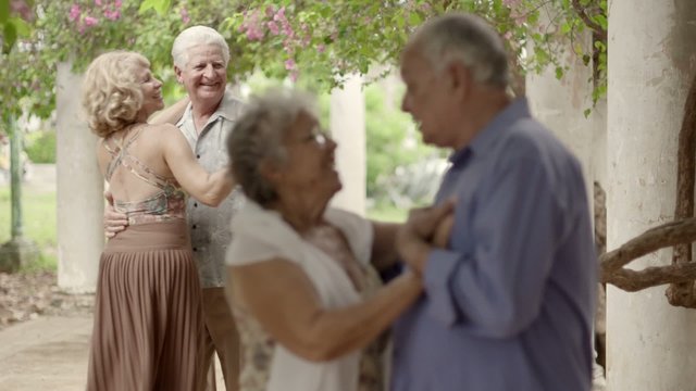 Old happy people dancing, couples of friends during dance
